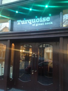 front of turquoise restaurant